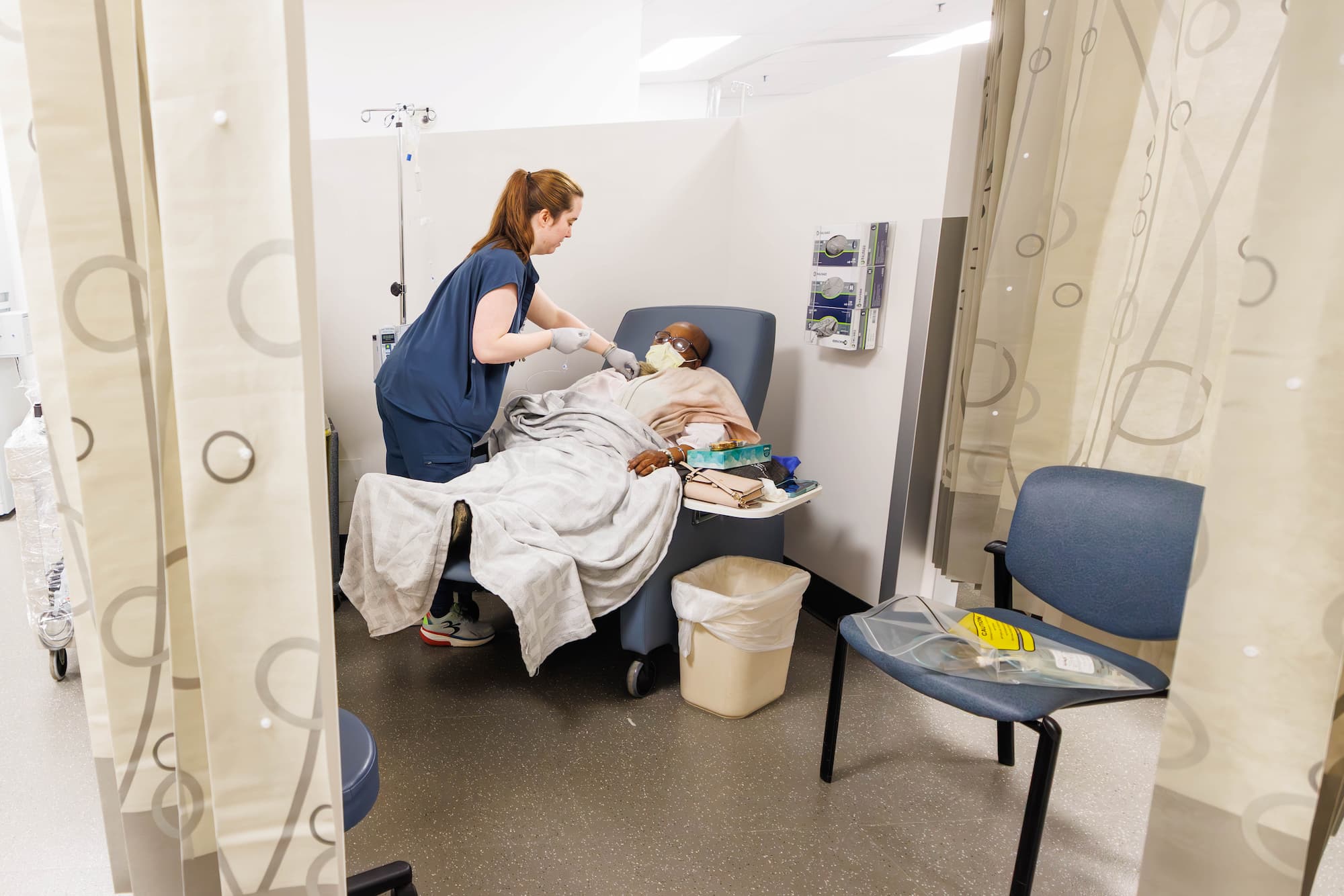 Registered Nurse Mattie Rials assists patient Ora Davis with treatment in the CCRI clinic.