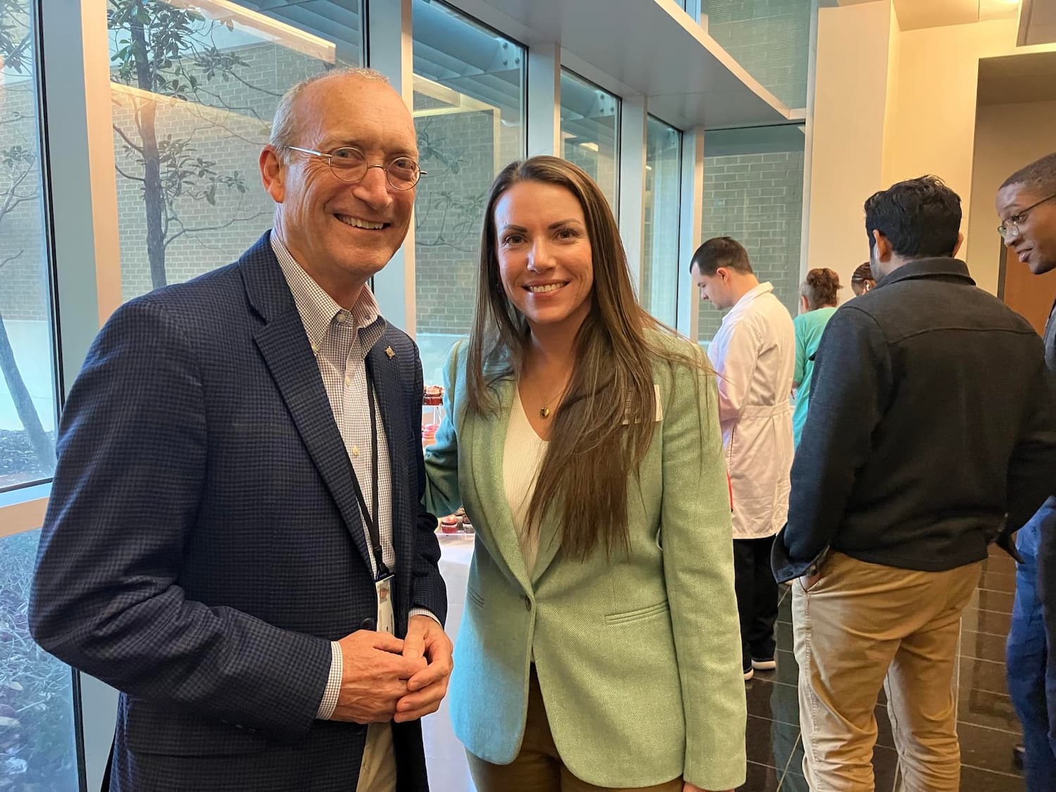 Dr. Leslie Musshafen congratulates Dr. Andrew Grady, director of the Center for Comparative Research, on his retirement.