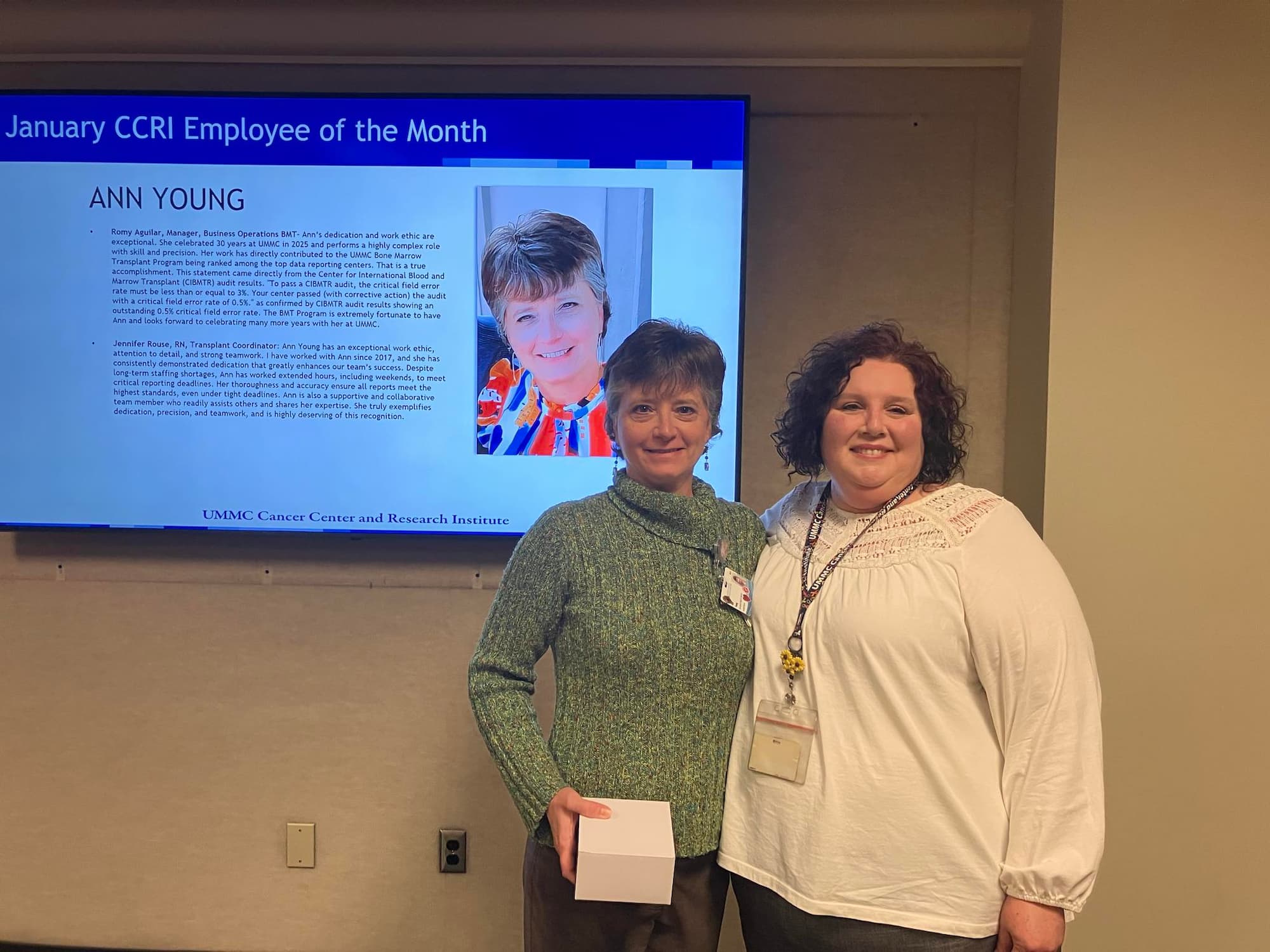 Ann Young, left, a data quality analyst at the Bone Marrow Transplant Unit, is presented CCRI Employee of the Month honors by Romy Aguilar, manager of business operations at the BMT Unit.
