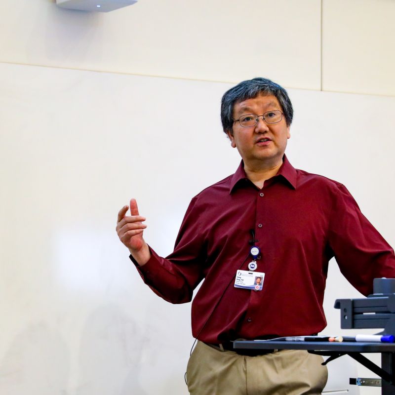 Dr. Yufeng Zheng is shown presenting a workshop on AI and deep learning at the John D. Bower School of Population Health.