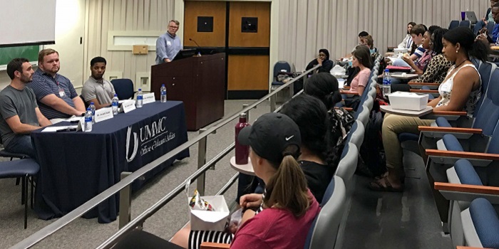 Students listen to an alumni panel