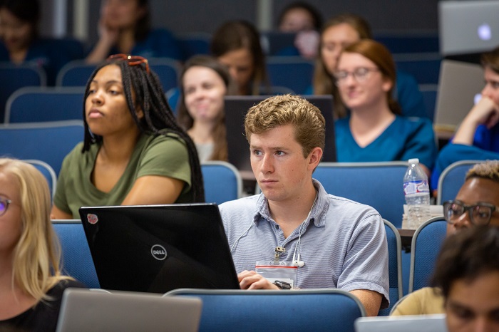 Students listen to lecture by Tom Adair