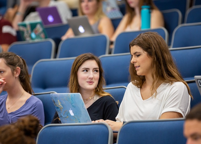 Students listen to a lecture by Tom Adair