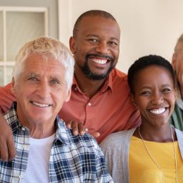 Three smiling older adults.