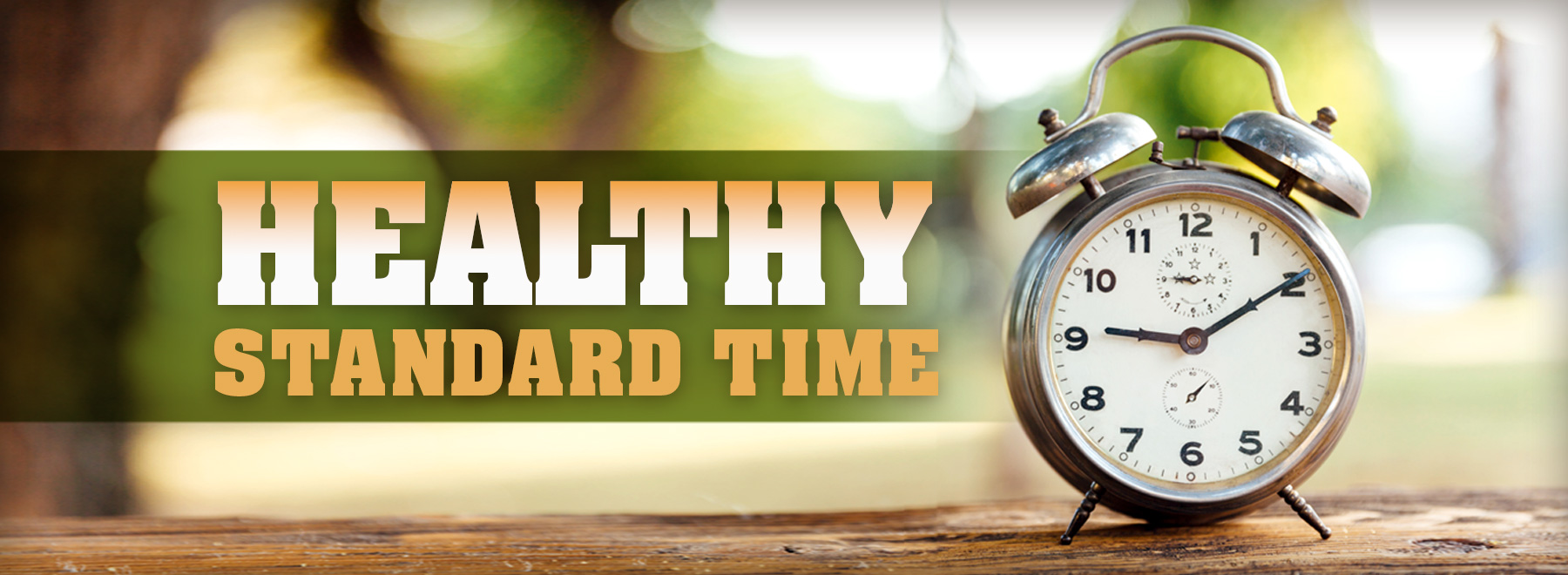 Clock on a wooden table outside with title treatment