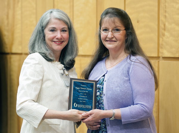 Dr. Janet Harris, left, associate dean for practice and community engagement in the School of Nursing, presents the 2014 Nurse of the Year Award to Denise Adams, a nurse in the pediatric emergency department.