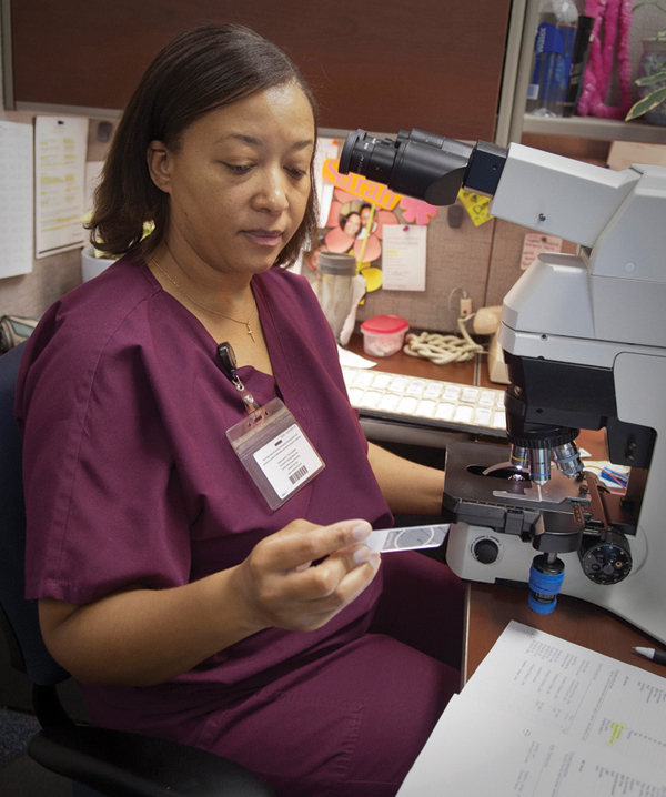 Sarah Short, cytotechnologist in the Department of Pathology, prepares to examine a patient's Pap smear.