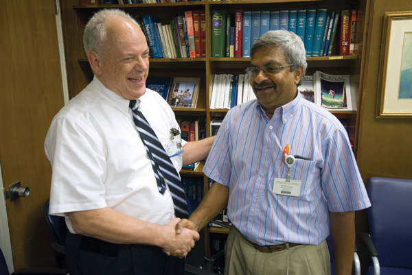 Bock enjoys a laugh while reminiscing with Dr. Charles H. Gaymes, professor of pediatric cardiology, at Bock's retirement party.