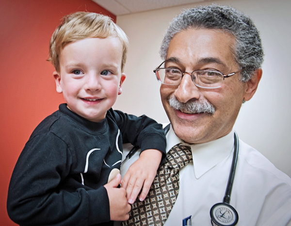 Dr. Makram Ebeid holds patient Wyatt Stout, 2, of Pass Christian during a visit following Wyatt’s heart-repair procedure done via catheter.