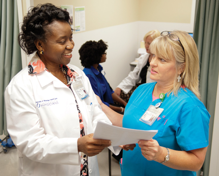 Olutade speaks to Kathryn Simmons, Student/Employee Health Services nurse.