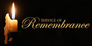 Lit candle with title of Service of Remembrance