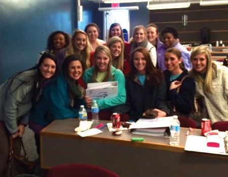 Dental hygiene students attend the board review course. 2. Dental hygiene students practice their CPR skills.