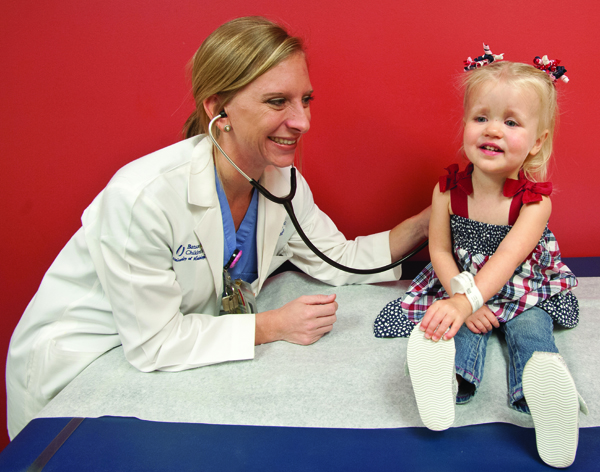 Nurse practitioner Keli Ballard listens to the heart of 2-year-old Abigail Morgan of Biloxi during a checkup exactly one week after the toddler underwent an innovative and rare surgery to repair a "hole" in her heart and a leaking mitral valve. The surgery by Dr. Ali Dodge-Khamati has been performed at only a handful of medical centers internationally.