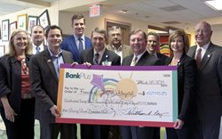 Football great Eli Manning, back row second from left, joined BankPlus president and CEO Bill Ray, front row second from right, in presenting a $627,195 donation generated by the Friends of Children's Hospital CheckCard. Joining in the presentation are, back row from left, Friends board members Susan Shands-Jones, Bruce Leach and Bryan Jones, Dr. Rick Barr, Suzan B. Thames Professor and Chair of Pediatrics, and Dr. Jimmy Keeton, distinguished professor and advisor to the vice chancellor. Front row from left, Rob Armour, Friends president and BankPlus executive vice-president and chief marketing & business development officer, Guy Giesecke, CEO of Children's of Mississippi and Dr. LouAnn Woodward, UMMC vice chancellor for health affairs and dean, School of Medicine.