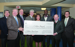 Sharing in the presentation of a $1.1 million check (from left) Steve Jent, tournament director of the Sanderson Farms Championship golf tournament; Johnny Lang, president of tournament host Century Club Charities, former UMMC Vice Chancellor for Health Affairs and School of Medicine Dean Dr. James Keeton; Gov. Phil Bryant; Friends board chair Sara Ray; Jackson Mayor  Tony Yarber; Sanderson Farms CEO Joe  F. Sanderson, Jr.; and Friends president Rob Armour.