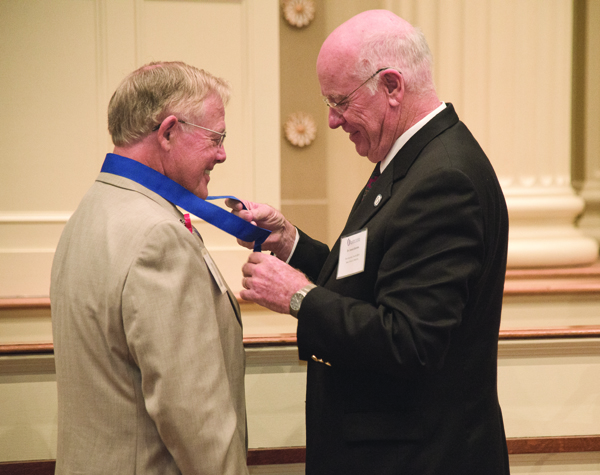 Dr. Ed Hill of Tupelo, left, receives his Class of 1964 commemorative medal from Dr. James Keeton, vice chancellor for health affairs and dean of the School of Medicine, shortly before addressing his fellow alumni.