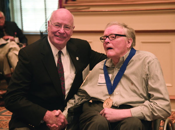 Dr. James Keeton, left, vice chancellor for health affairs and dean of the School of Medicine, congratulates Dr. Jack Aldridge Jr. of Brandon, a recipient of the Class of 1964 commemorative medal. Aldridge passed away in October.