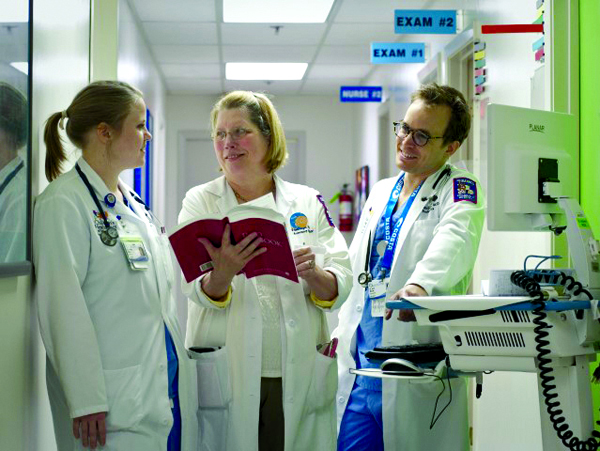 Weisenberger with pediatric residents Dr. Elizabeth McKey, left, and Dr. Josef McLean.