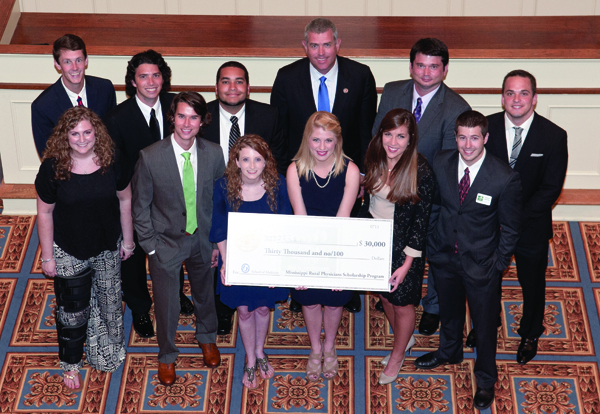 State Rep. Phillip Gunn, back row, center, Mississippi Speaker of the House, is on hand to congratulate the Medical Center’s recipients of the 2014 Mississippi Rural Physicians Scholarships, July 10 at the Old Capitol Museum in Jackson. The M1s are, front row, from left, Kaycee Burcham of Iuka, Evan Ciarloni of Grenada, Hollie Ables of Florence, Rachel Sharp of Sturgis, Meagan Henry of Pontotoc and Robert Barnes of Coldwater. Back row, from left, are Ben Lambert of Como, Ryan Humphries of Louisville, Nicholas Boullard of Brandon, Gunn, Brad Murray of Glen and Johnny McKenzie of Tylertown.