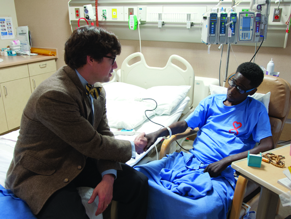 UMMC abdominal transplant surgeon Dr. Mark Earl visits Utica resident Dennis Mitchell, 33, who on April 14 received the 50th liver transplant since the Medical Center’s program was jump-started in March 2013.