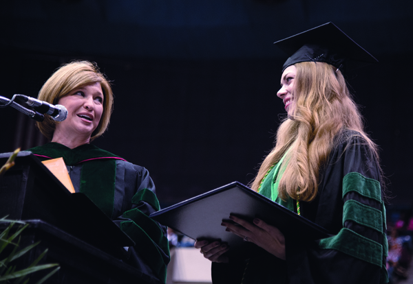 Woodward congratulates Julie Dhossche, School of Medicine graduate, during commencement 2015. Dhossche won the Waller S. Leathers Award for the medical student with the highest academic average for four years.