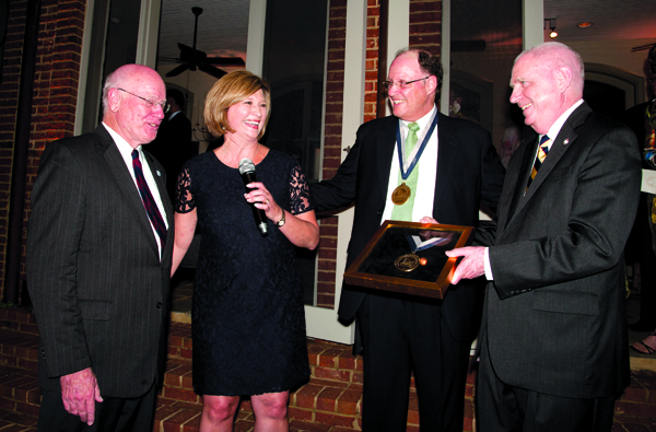 Dr. Ed Harmon, second from right, is honored as the first James E. Keeton, M.D. Chair of Pediatric Urology. Celebrating with him are, from left, Keeton; Dr. LouAnn Woodward, vice chancellor for health affairs and dean of the School of Medicine; and Dr. Dan Jones, chancellor of Ole Miss.