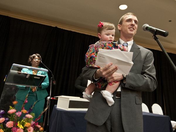 Darren Scoggin, holding daughter Julie, announces that he will be staying close to home for his residency during Match Day 2014.