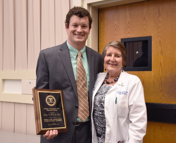 Moss receives the Caldwell Award from Beebe.