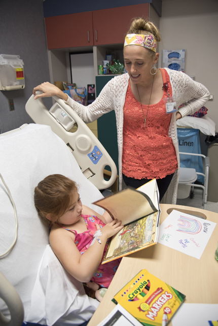 Jessica Warren works with Randi Reese Lott on a reading lesson.