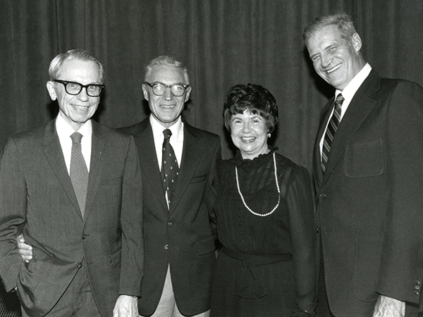 In this undated photo, four members of the original faculty and staff at UMMC reunite. They are, from left: Dr. Peter Blake, the first director of the Introduction to Clinical Medicine course; Dr. Orlando Andy, first head of the Department of Neurosurgery; Irene Graham, UMMC's first librarian; and Dr. Warren Bell, chair of what was then a separate administrative unit: the Department of Clinical Laboratory Sciences, for Clinical Pathology.