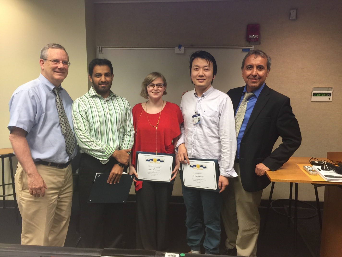 Brodell, left, and Gomez, right, visit with graduate students participating in the event, from left, Nasir Butt, Kathryn Hellman and Lin Wang.