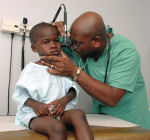 Dr. Audwin Fletcher examines 3-year-old Edward Smith of Jackson.