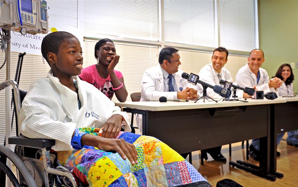 Members of the University of Mississippi Medical Center’s Pediatric Heart Transplant Program react to 13-year-old Malcolm Jones of Winona as he talks about going home to play. Jones is the first pediatric heart transplant patient for the reactivated program at UMMC. Attending the news conference to announce the surgery are, from left, Jones, his mother Gina Jones, Dr. Avi Aggarwal, assistant professor of pediatrics and medical director of the pediatric heart transplant program, Dr. Daniel DiBardino, assistant professor of surgery, Dr. Jorge Salazar, associate professor of surgery and chief of the congenital heart program, and Dr. Michelle Sheth, assistant professor of anesthesiology.