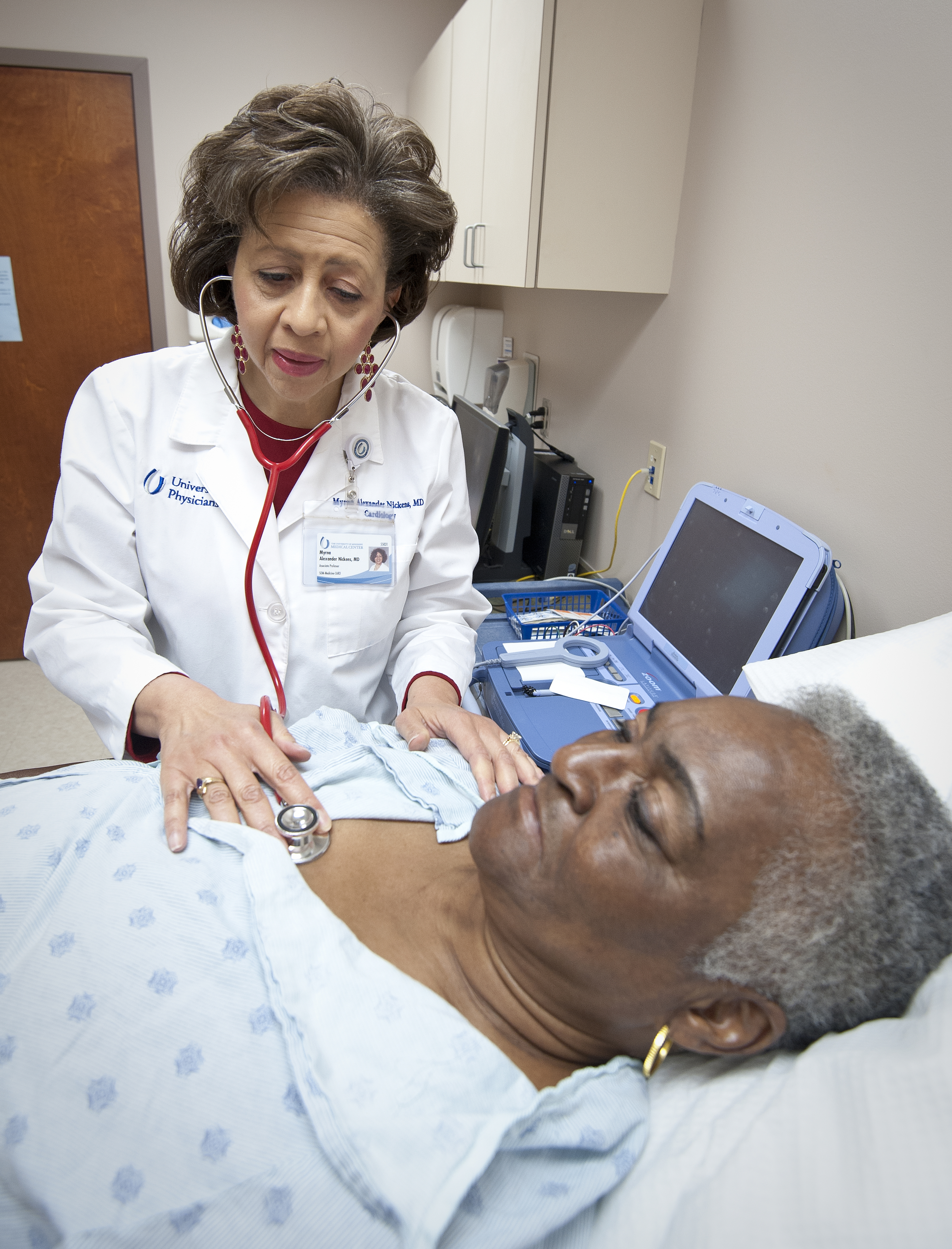 Dr. Myrna Alexander listens to the heart of Elizabeth Greer of Lexington