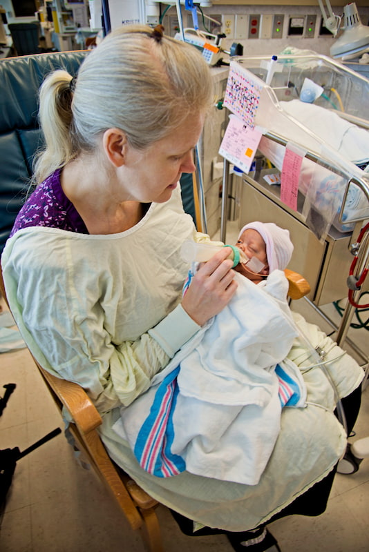 Kimberly Fugate gives Kristen, one of her four identical daughters, her first bottle in the Neonatal Intensive Care Unit at the University of Mississippi Medical Center.