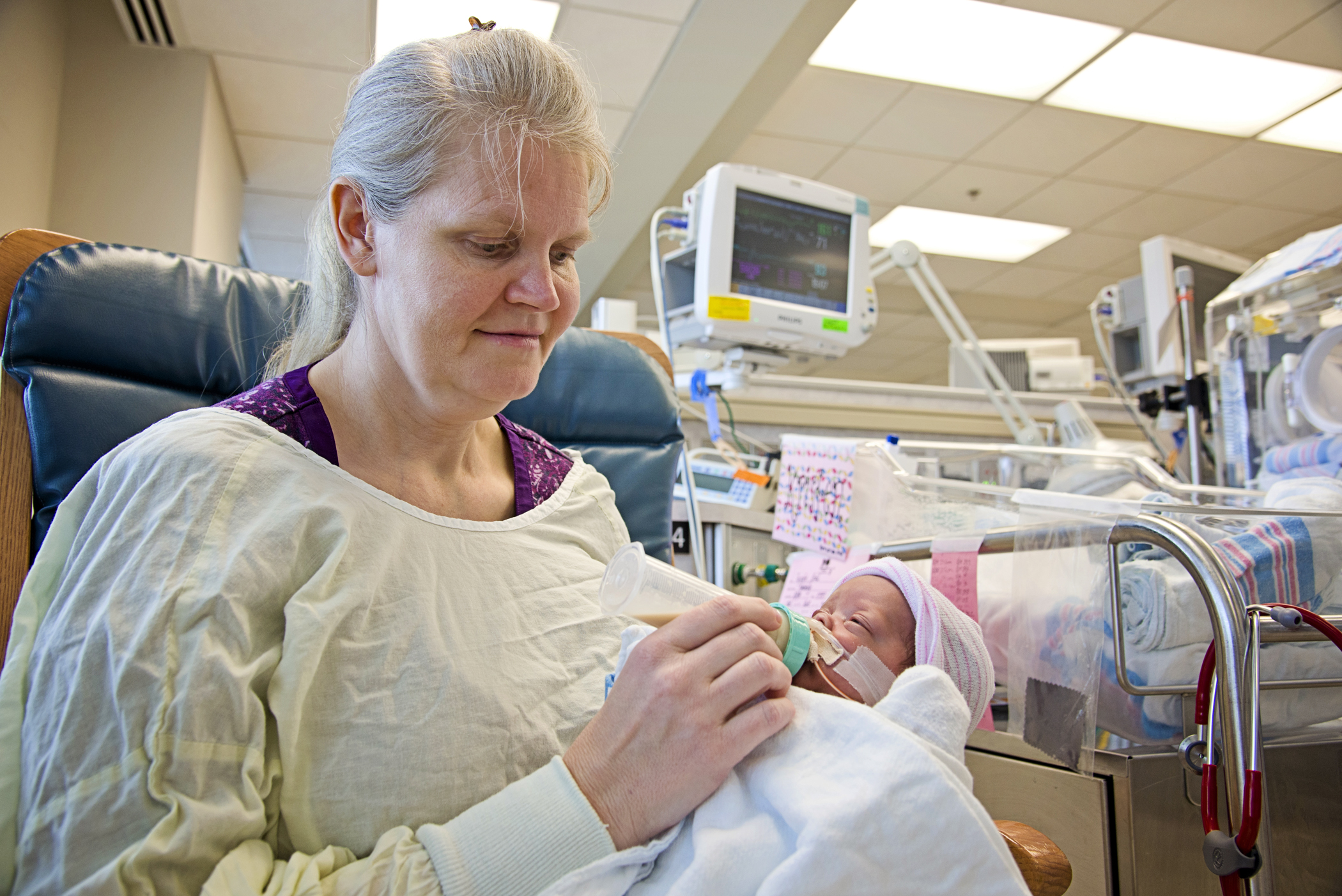 Kimberly Fugate gives Kristen, one of her four identical daughters, her first bottle in the Neonatal Intensive Care Unit at the University of Mississippi Medical Center.