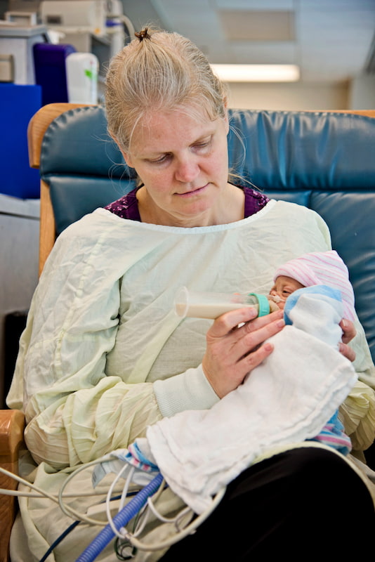 Kimberly Fugate gives Kayleigh, one of her four identical daughters, her first bottle in the Neonatal Intensive Care Unit at the University of Mississippi Medical Center.