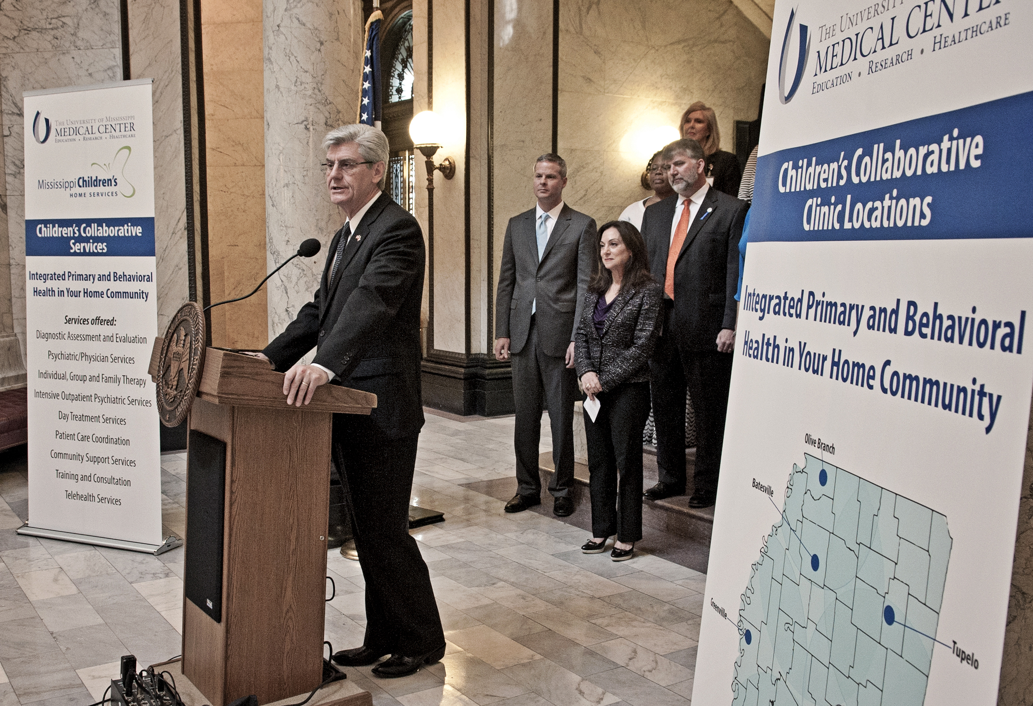 Gov. Phil Bryant discusses the Children's Collaborative along with partnership key players, starting front row left, Dr. David Elkin, UMMC professor of psychiatry, Dr. Susan Buttross,  Karen Goodman, MCHS intake coordinator, Terry Hight, MCHS COO, and Kay McRee, MCHS director of development.