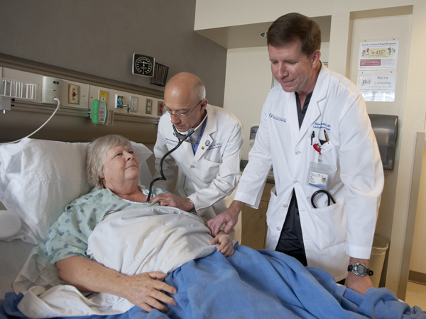 McMullan, right, and Aru check in on their patient