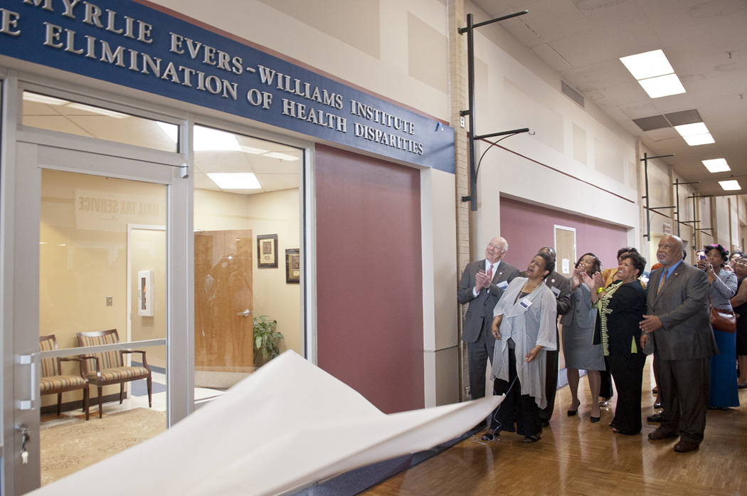 Dr. Myrlie Evers-Williams, foreground, unveils the sign marking the institute.