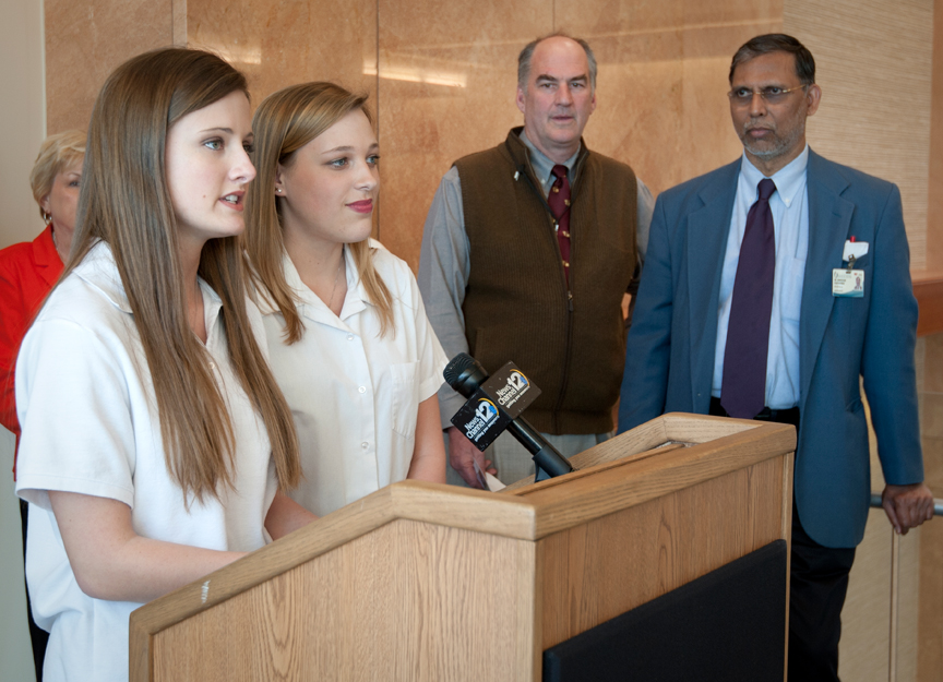 Jackson Prep seniors Anna Grace Buchanan, left, and Cara Lee Crawford speak to UMMC Cancer Institute researchers.