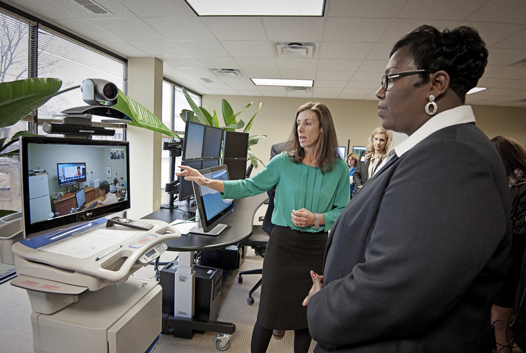 Dr. Kristi Henderson, left, UMMC director of Telehealth and chief advanced practice officer, and Trina George, right, Mississippi state USDA director of rural development, demonstrate a telehealth system.