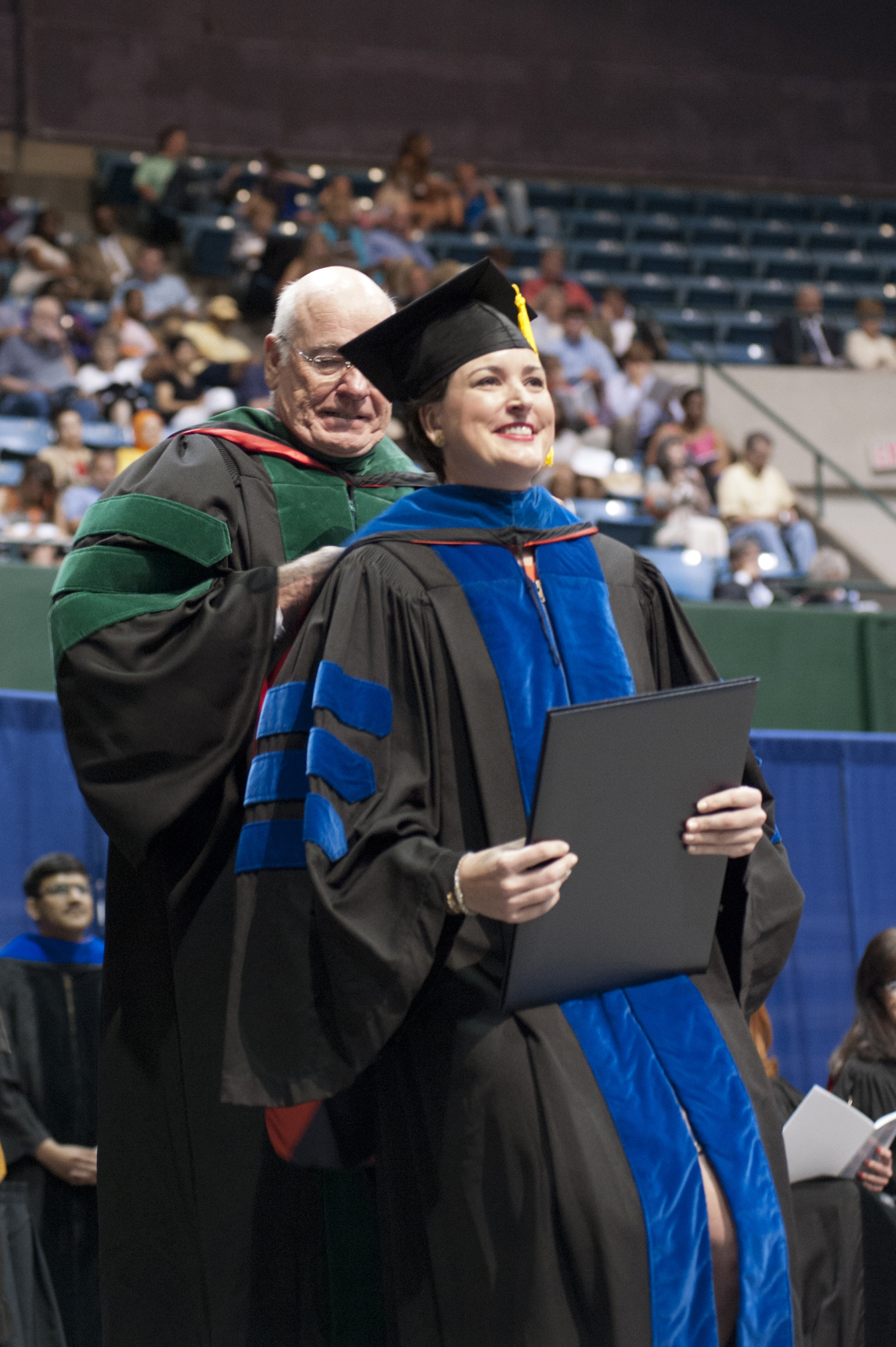 Mechelle Keeton of Jackson is hooded by her father, University of Mississippi Medical Center Vice Chancellor James Keeton, as she receives her Doctor of Philosophy in Clinical Health Sciences during commencement ceremonies May 23 at the Mississippi Coliseum in Jackson.