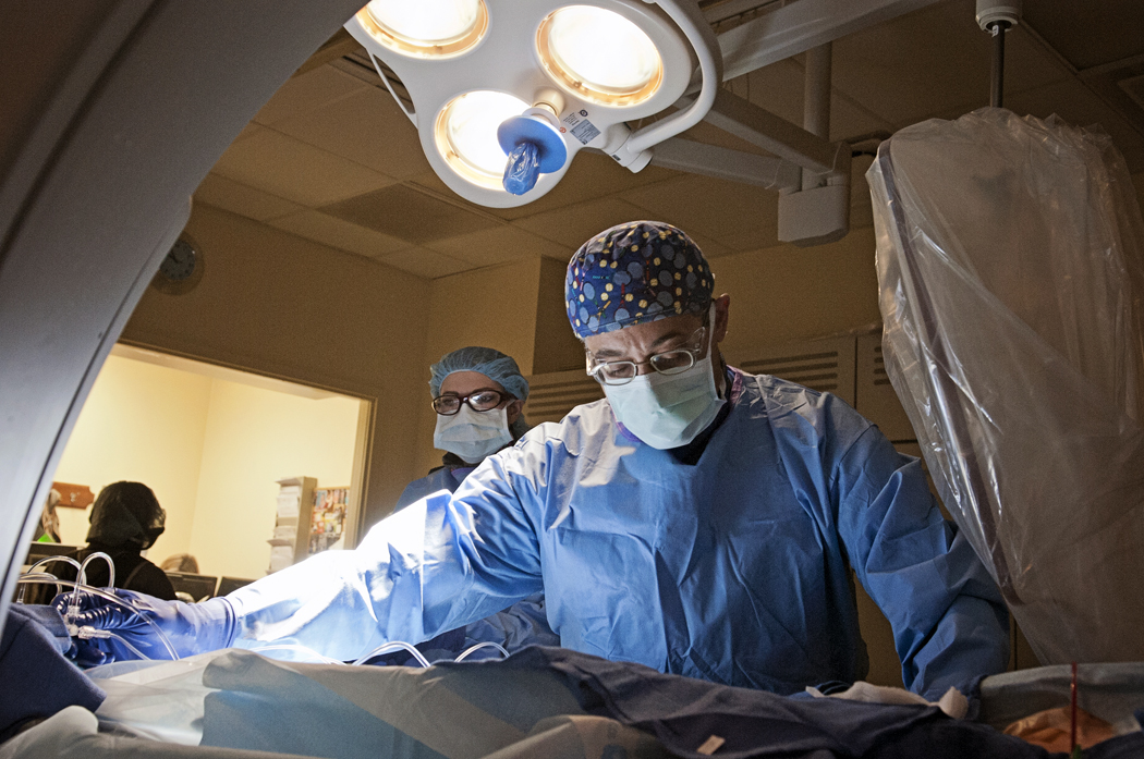 Dr. Makram Ebeid, UMMC professor of pediatric cardiology and director of the Pediatric Catheterization Lab, uses a catheter to make a repair in a child’s heart.
