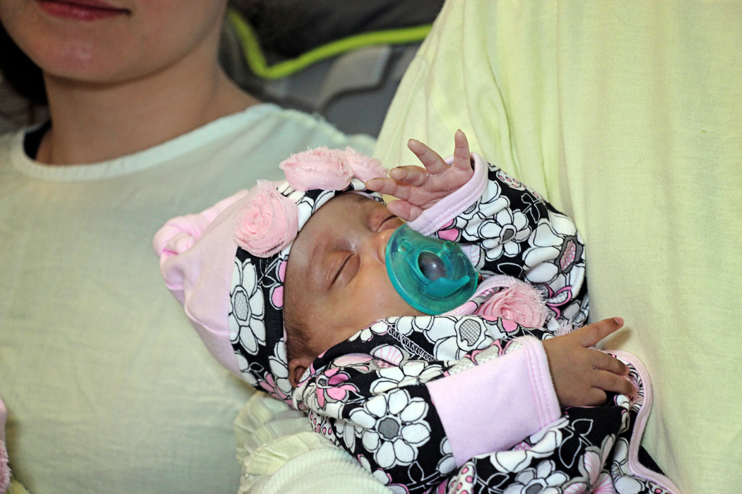 Kelsey Roxanne Fugate snuggles in her dad's arm before her release from the neonatal intensive care unit at Batson Children's Hospital.