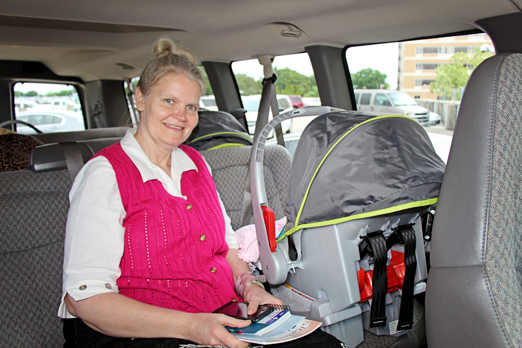 Kimberly Fugate buckles in daughter Kelsey Roxanne for her first car ride home.