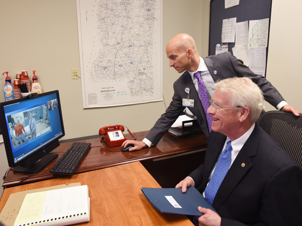 As Dr. Alan Jones, professor and chair of the Department of Emergency Medicine, makes a video connection, Sen. Wicker prepares to speak to David Putt, CEO of UMMC's hospital in rural Lexington, in that hospital's emergency room.