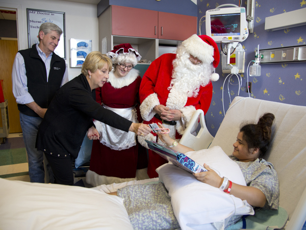 Gov. Phil Bryant and wife Deborah Bryant, along with Santa and Mrs. Claus, visit Batson Children's Hospital patient Joanna Belmontes Dec. 24.