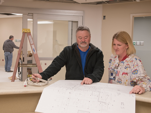 David Walker of S&C Sound and Communications and Lawrence go over plans for renovation of the Lexington hospital's ED.