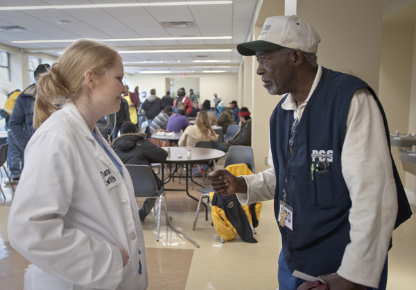 Dana Smith assures Grace Place regular Leon Buggs about his blood pressure.